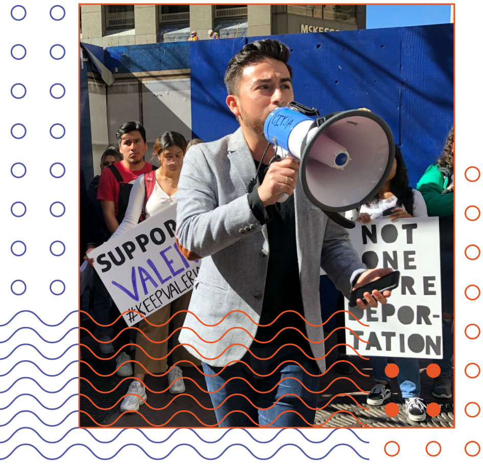 Edwin Carmona-Cruz speaking into a megaphone at a rally