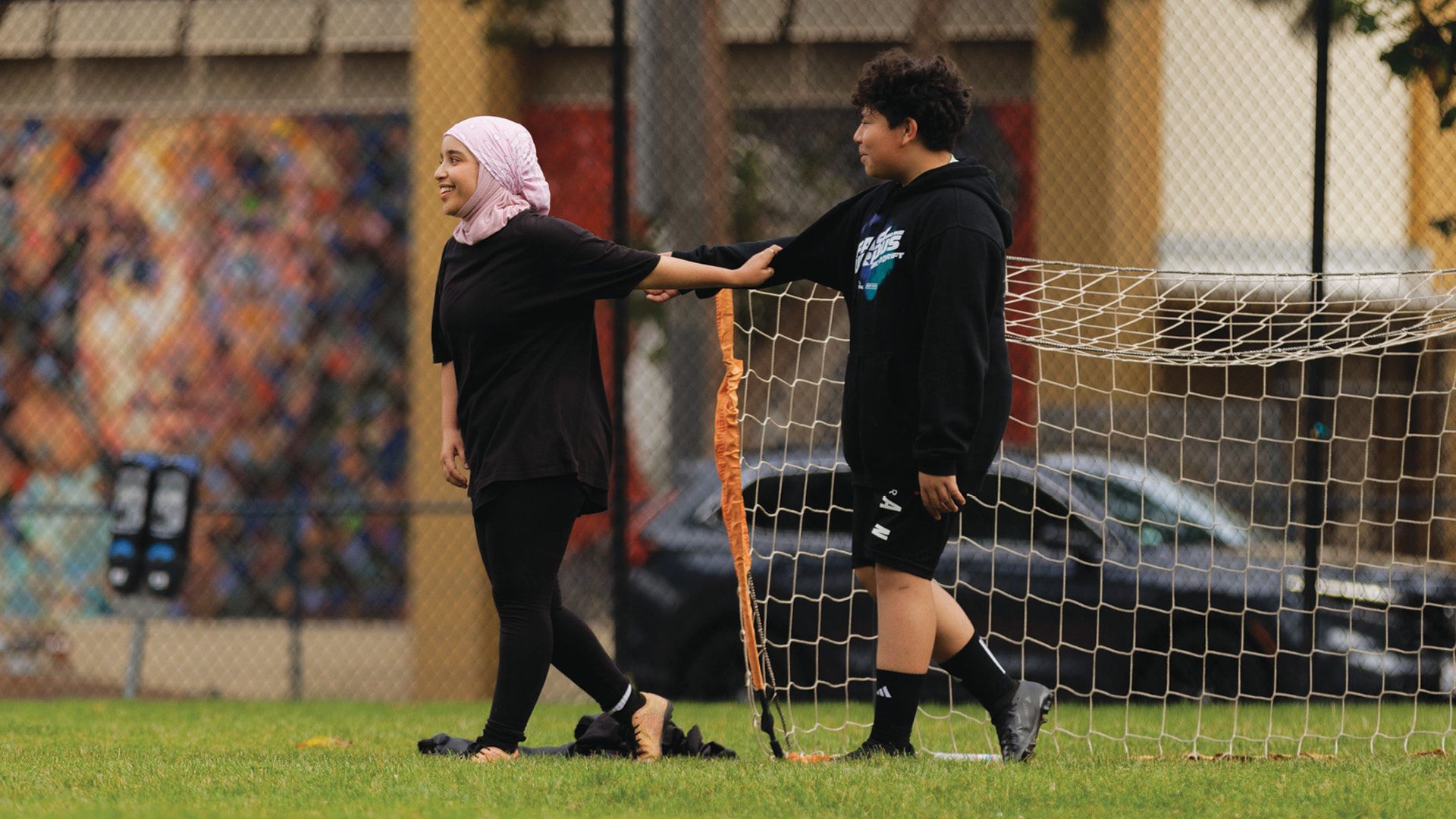 Two soccer players in front of goal.