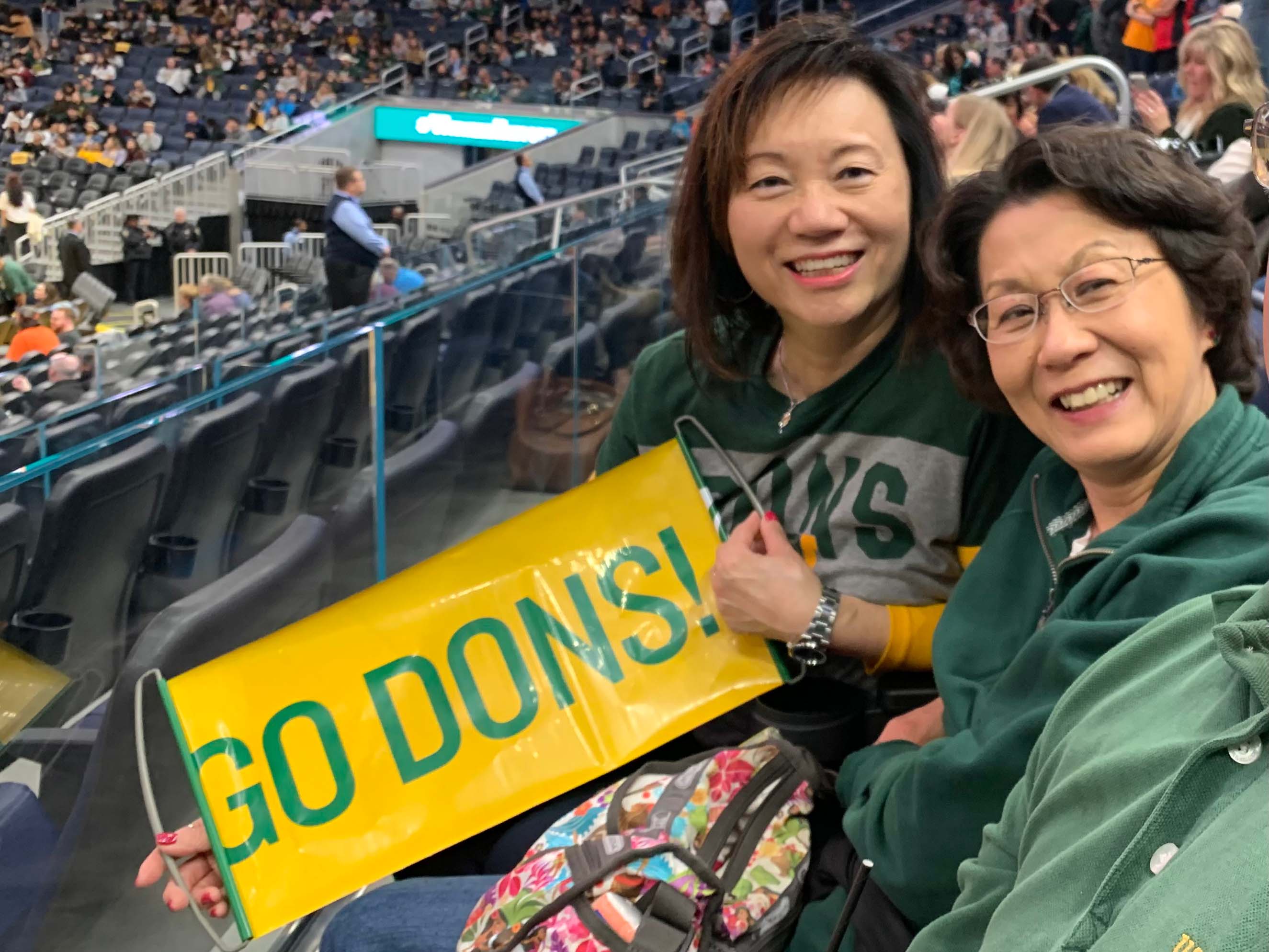 two people cheering on USF basketball