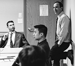 Ken Goldstein leaning against wall lecturing class