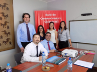 Students and professionals gathered behind a desk