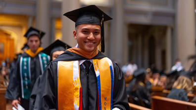 student in cap and gown during commencement ceremony