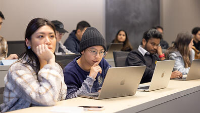 Students in classroom looking at laptops