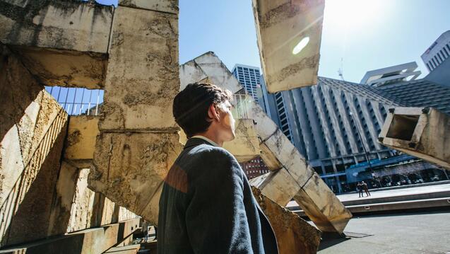 Student walks by a fountain in downtown SF.