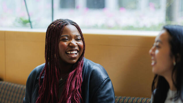 Student smiling and chatting with a friend