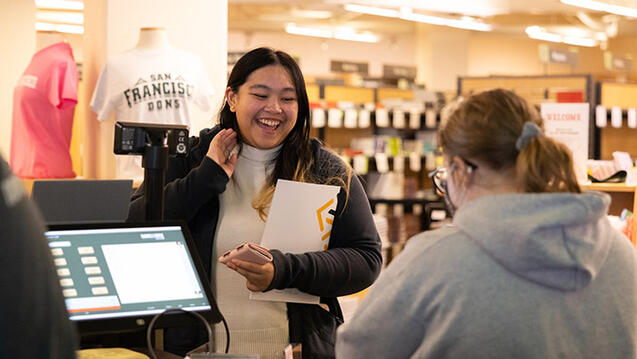 student checks out at the bookstore