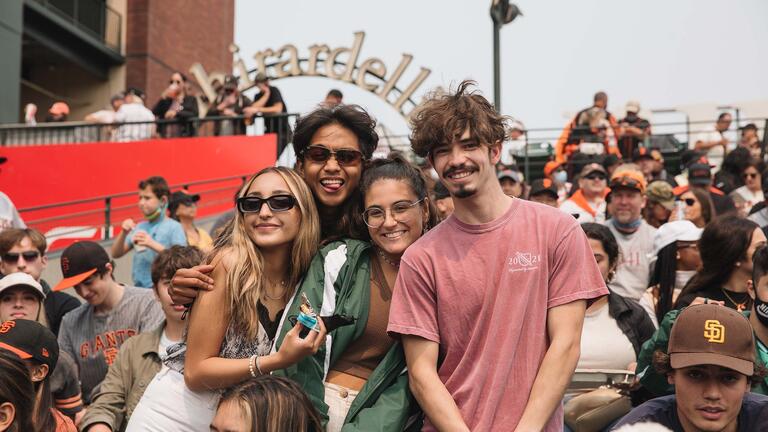 Students posing in the stands at an SF Giants game.