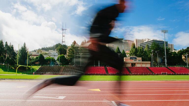 A runner on the track at Kezar Stadium.