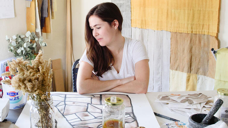 Sofia V. Gonzalez looks over a table of art supplies