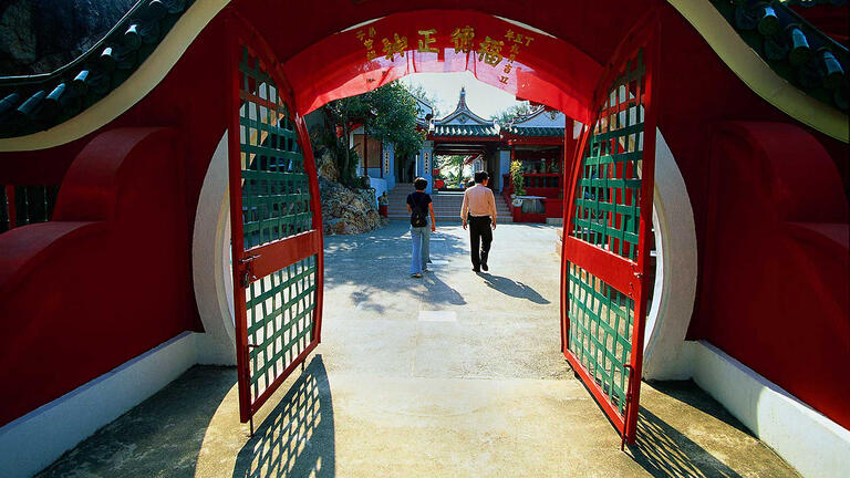 People walking through gate.