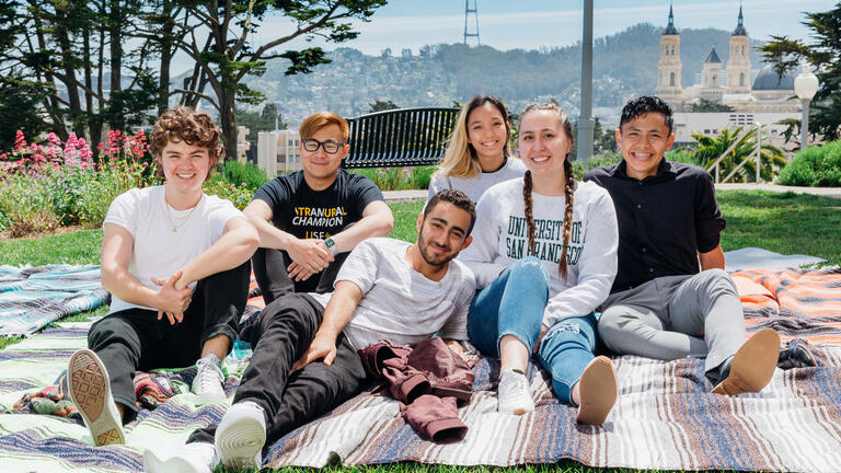 USF students sitting on picnic blanket on Lone Mountain