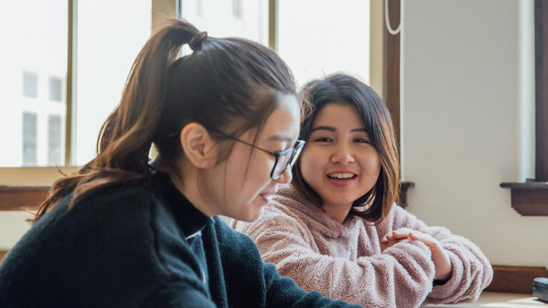 Students smiling in class.