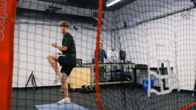 Blake Wittman throws while Professor Gerwyn Hughes watches.