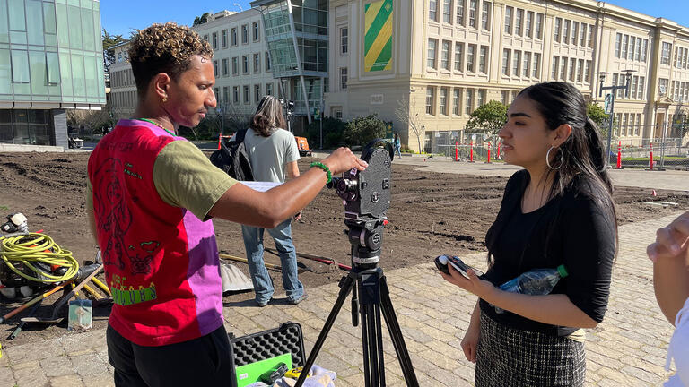 Two USF students filming on campus for class