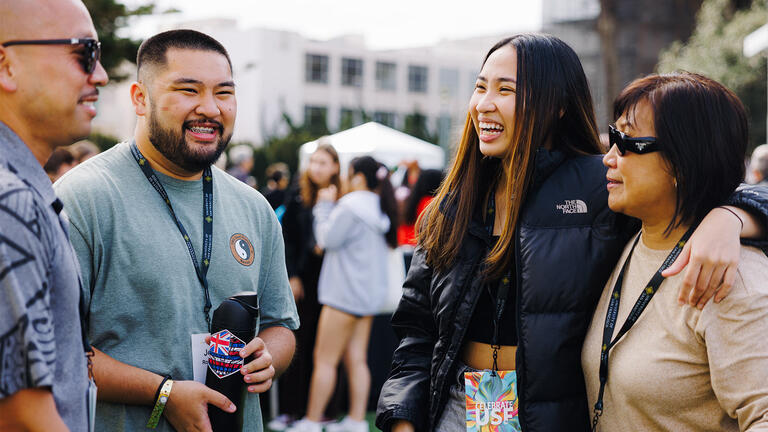 USF alumni smiling and talking