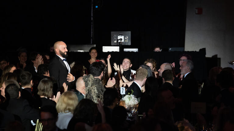 Craig Santos Perez walks to stage at National Book Awards