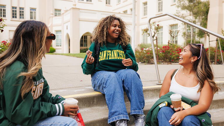 students eat together on school steps