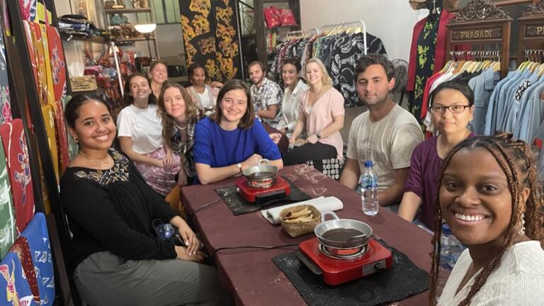 a group of students gather for a meal while