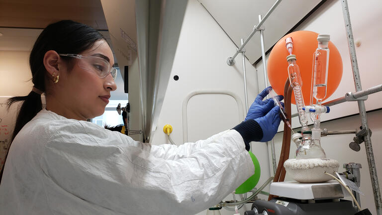 student using chemistry equipment