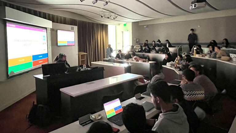 Students watch a presentation in a classroom