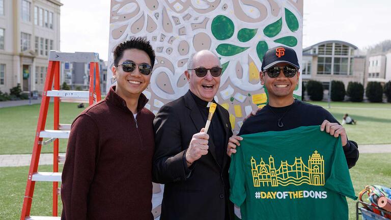 USF President, Fr. Paul Fitzgerald with students at the Community Mural