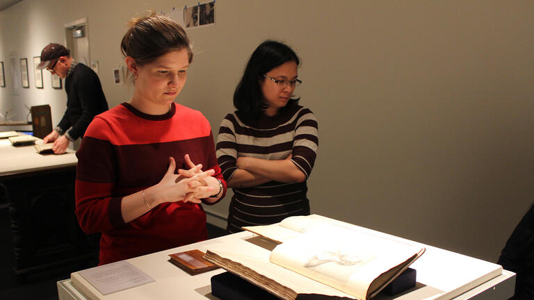 students look at book