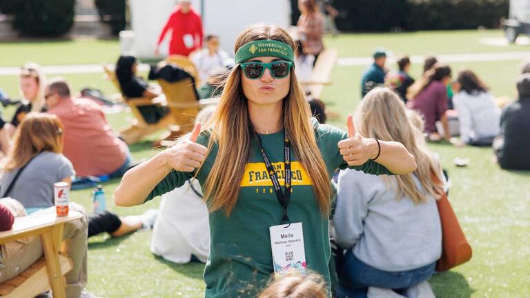 USF alumni giving a thumbs up