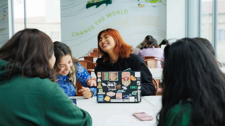 Students sitting together, laughing