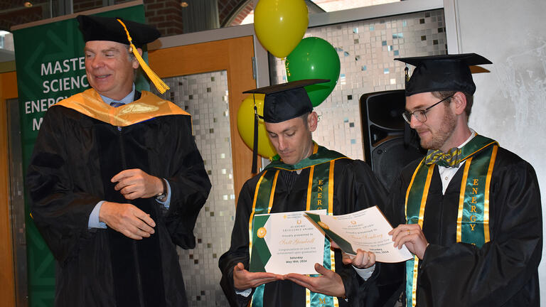 students receiving awards at graduation ceremony