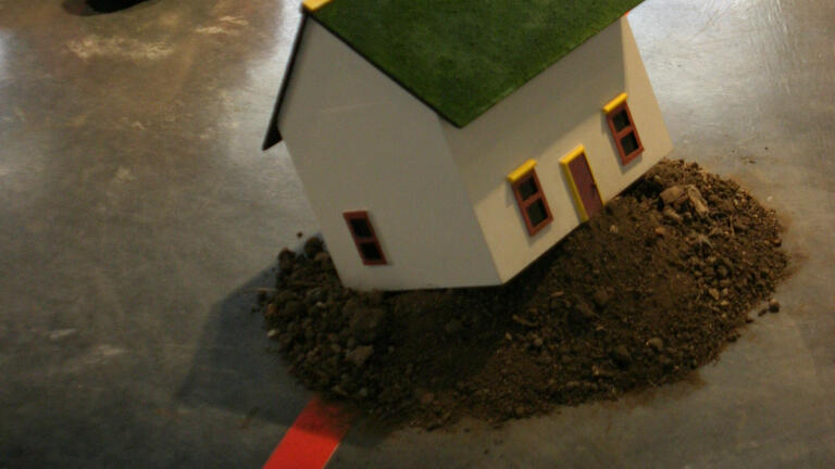 A miniature house on gray floor