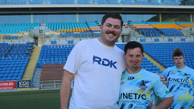 usf student stands with youth at a community sports club in australia