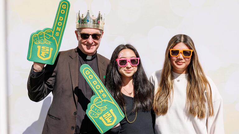 Father Fitzgerald posing with students