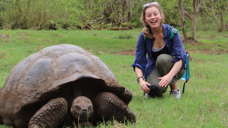 Student with a giant tortoise