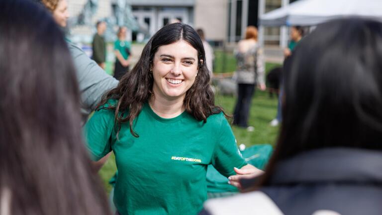 USF representative at a fair table speaking with students