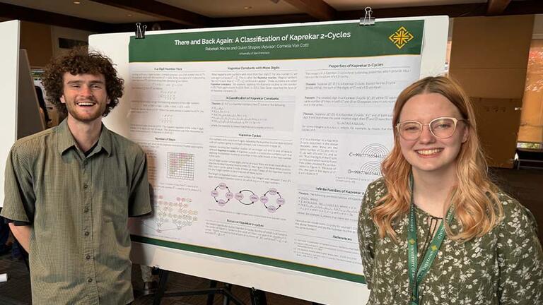 Students standing in front of a research poster