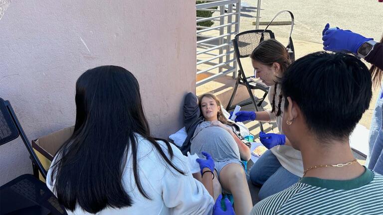 Nursing students assisting a pregnant person