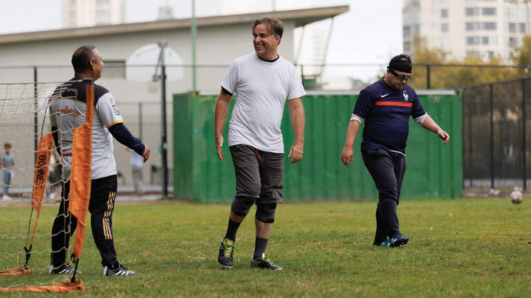 A group of adults playing soccer