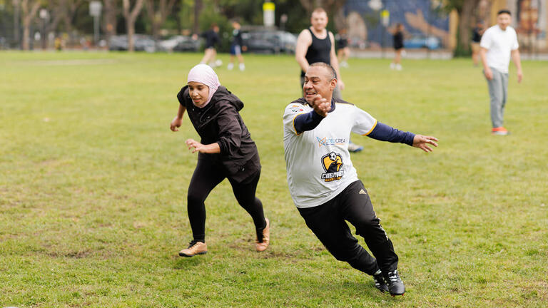 Two soccer players running.