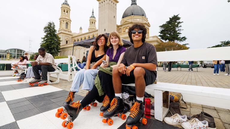 Three USF students at a skating event on campus