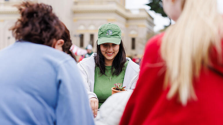 Student at the succulent planting station