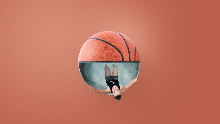 Student in an ice bath that is shaped like a basketball