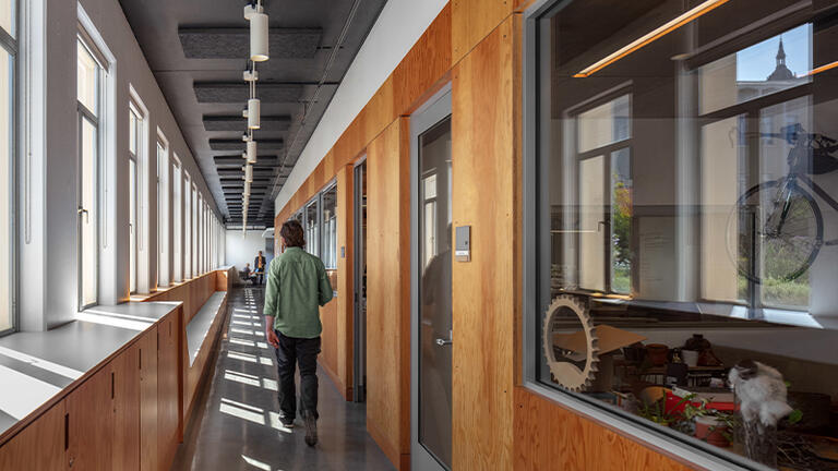 Person walking down a hallway in the Innovation Hive