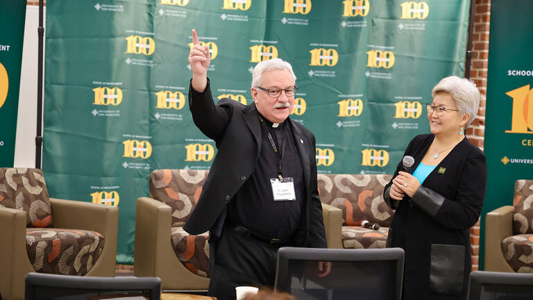 John Fitzgibbons and Otgo Erhemjamts speak to event attendees