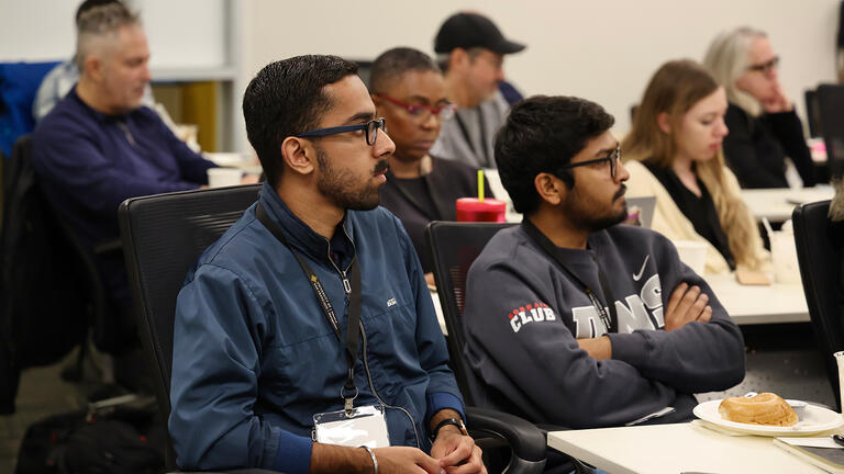 audience listens during centennial event
