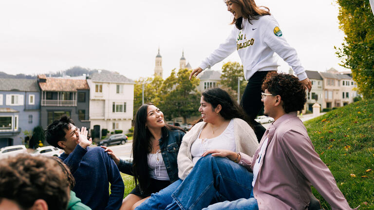 students hanging out on the grass on usf campus