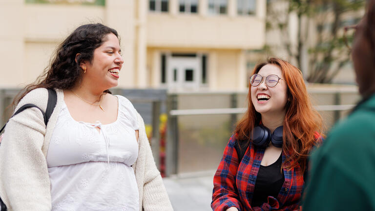 two students laughing together outside