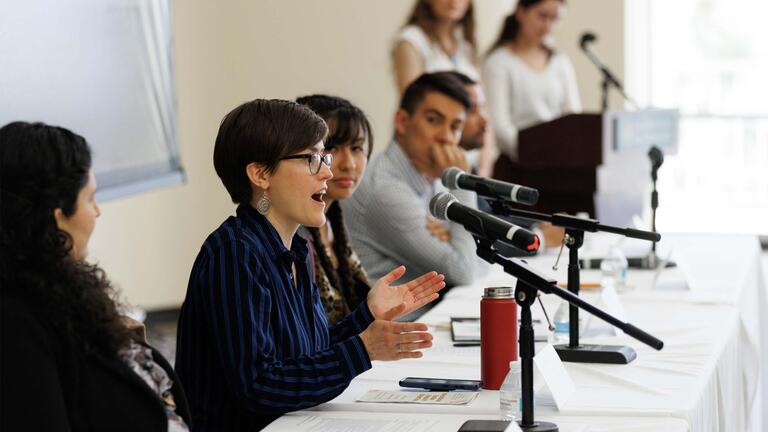 students and alumni presenting at a panel