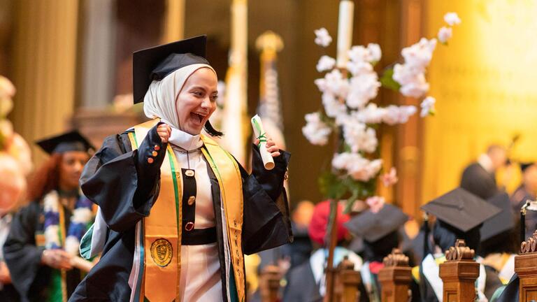 graduating student walking down church aisle