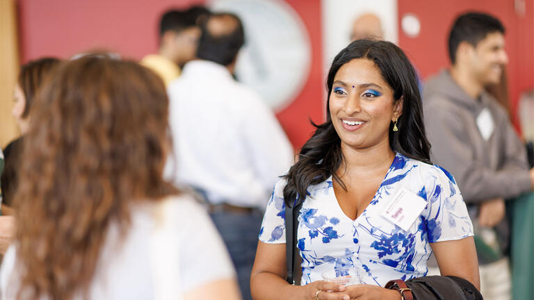 Student in blue and white dress chatting
