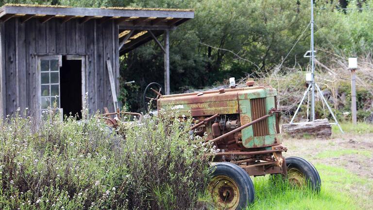 Tractor in front of old barn at Star Route Farms